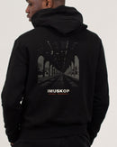 IMUSKOP Under The El Hoodie in black, worn, back with the elevated train print
